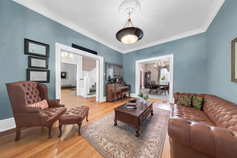 front parlor with original wood pocket doors and chandelier at 19 Occident Avenue in Stapleton Heights, Staten Island