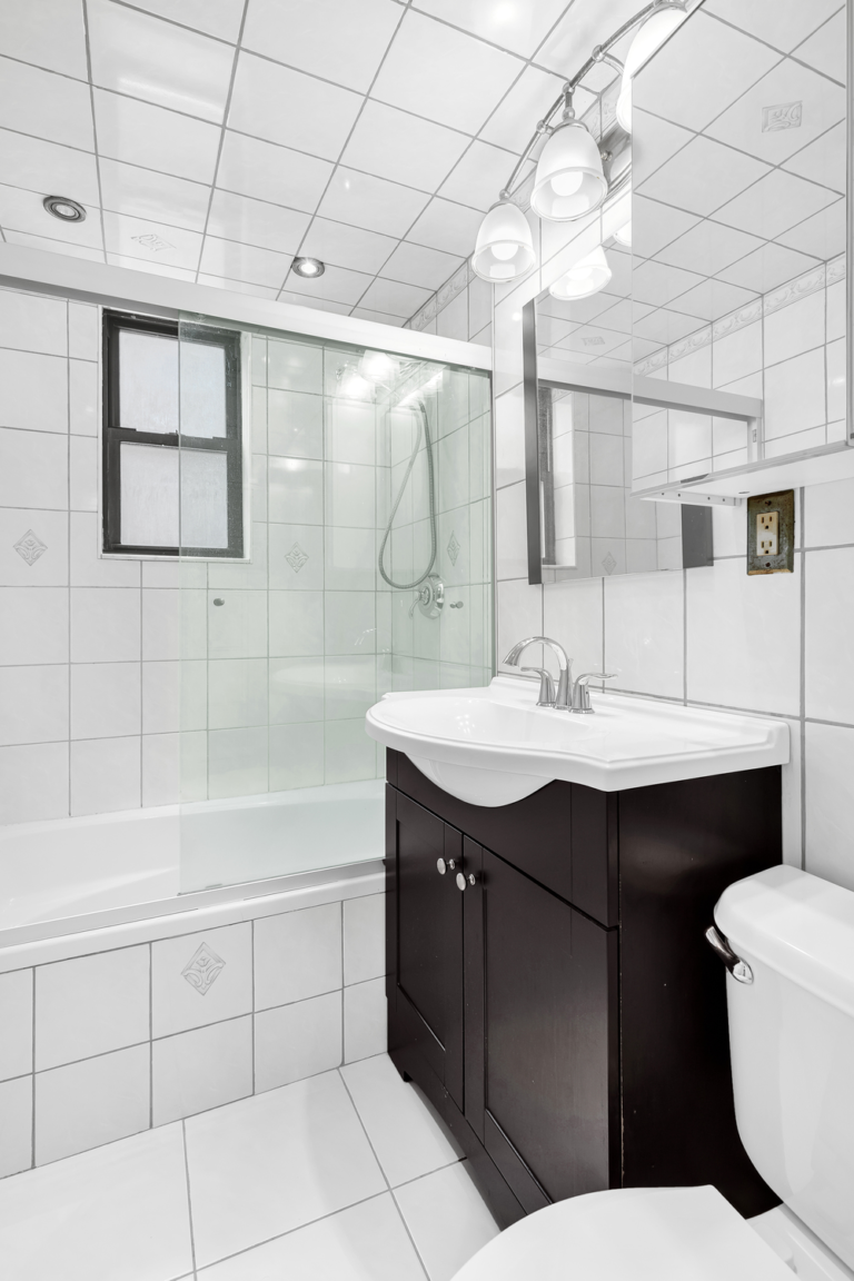 bathroom with tub and glass shower at 9511 Shore Road Apt 313 in Bay Ridge, Brooklyn