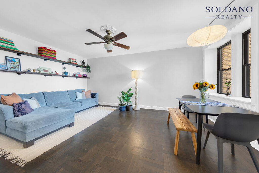 Living room at 6702 Ridge Boulevard Apt 4F, Bay Ridge, Brooklyn, with herringbone oak floors, a ceiling fan and a dining table by the windows