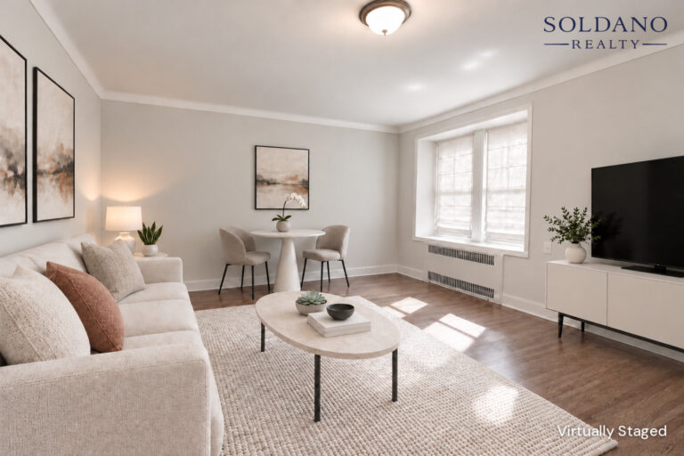 Living room with a pair of windows in a deep window bay and crown moulding at 9281 Shore Road Apt 122 in Bay Ridge, Brooklyn